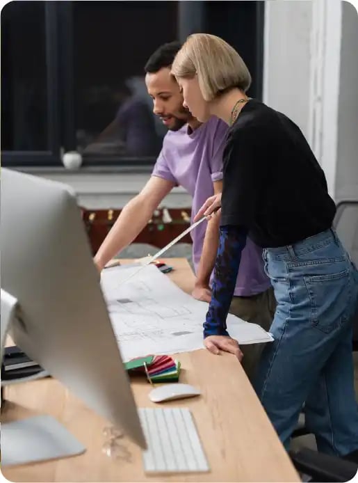 male and female reviewing plans